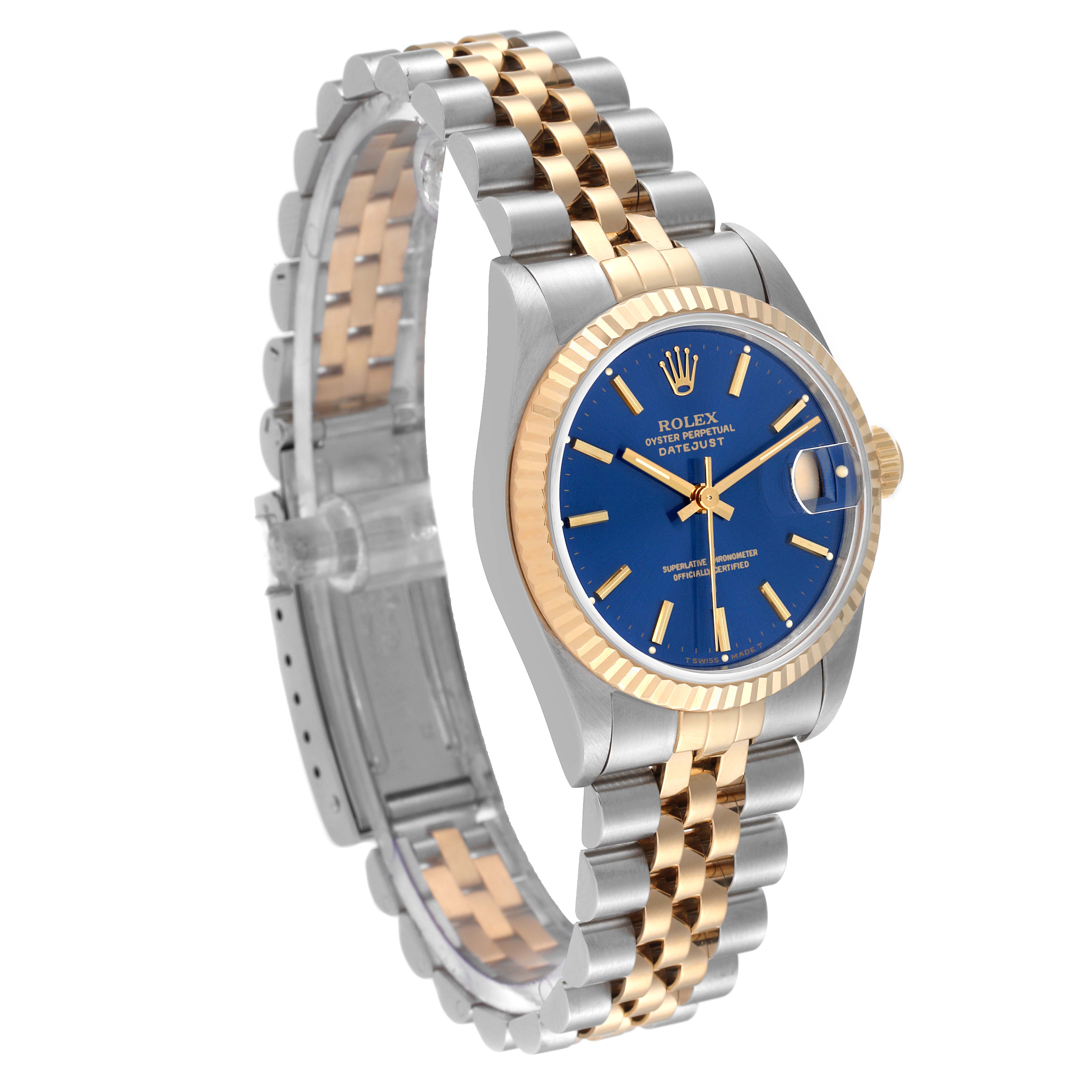 The image shows a Rolex Mid-Size 68273 Women's Steel and Gold (two tone) Blue Dial 68273 Women's Steel and Gold (two tone) Blue Dial Datejust watch at a three-quarter angle, highlighting the blue dial, fluted bezel, and two-tone bracelet.
