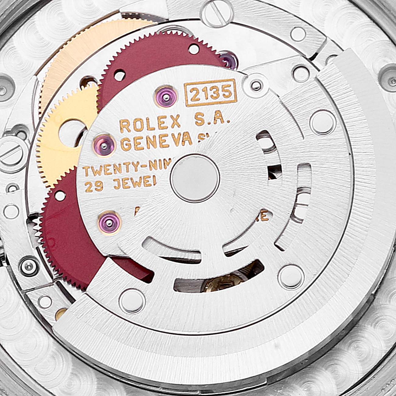 This close-up image shows the internal movement mechanism of a Mid-Size Rolex watch, including gears and the model number "2135."