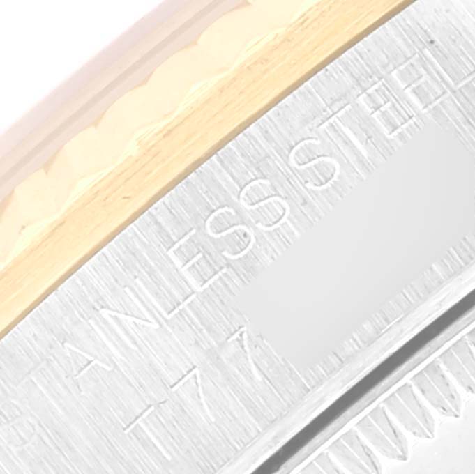 This close-up image of a Rolex Mid-Size 68273 Women's Steel and Gold (two tone) Blue Dial 68273 Women's Steel and Gold (two tone) Blue Dial watch shows part of the stainless steel back case with an engraving.