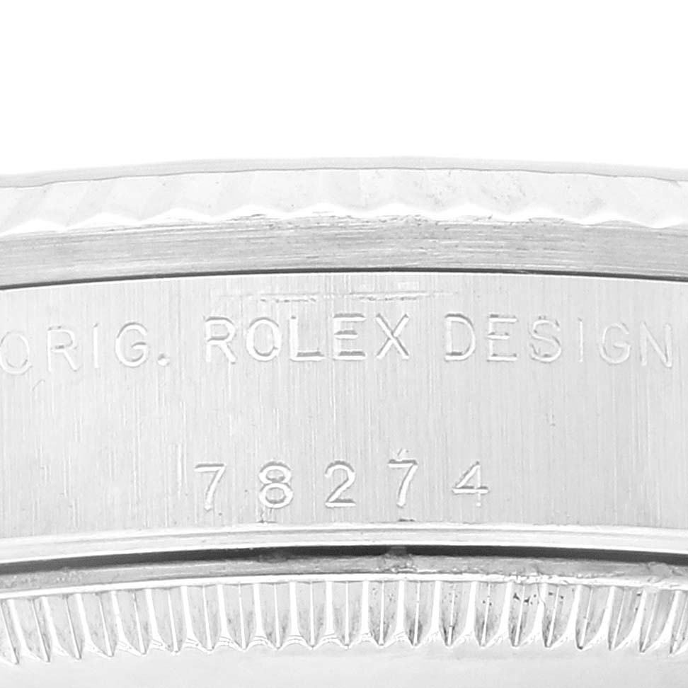 This image shows a close-up of the side of a Rolex Mid-Size 78274 Women's Stainless Steel Black Dial 78274 Women's Stainless Steel Black Dial watch case, highlighting the model number "78274" and "ROLEX DESIGN" engraving.