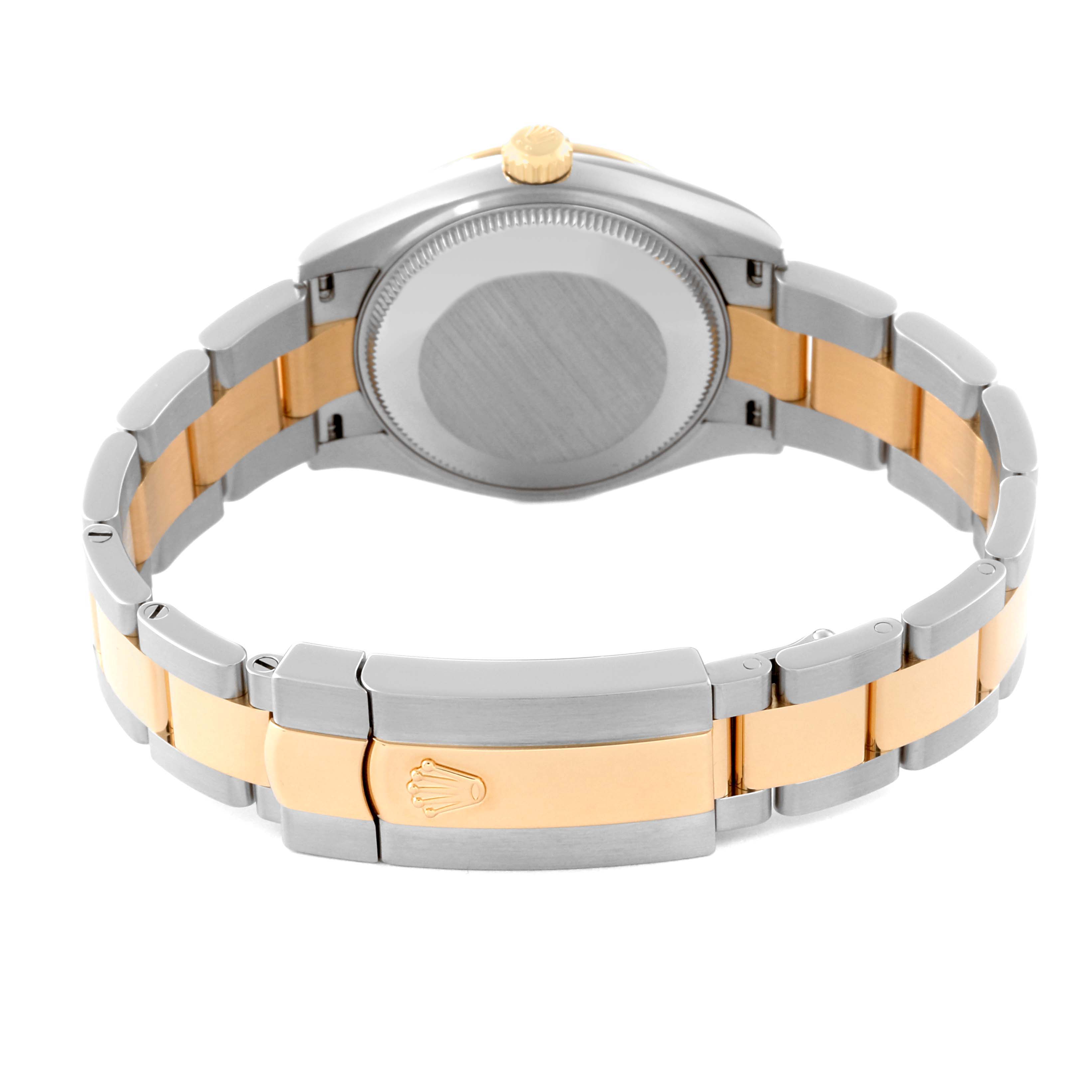 The image shows the back case and two-tone bracelet of a Mid-Size Rolex watch at an angle focusing on the clasp and case back.