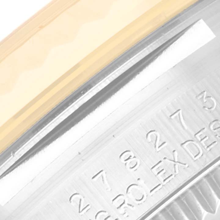The image shows a close-up of the side of a Rolex Mid-Size 278273 Women's Steel and Gold (two tone) Green Dial 278273 Women's Steel and Gold (two tone) Green Dial watch, focusing on the engraving and part of the bezel.