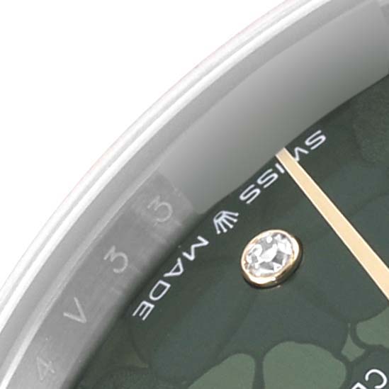 The image shows a close-up of the dial and bezel of a Mid-Size Rolex watch with a focus on the Swiss Made text and a diamond marker.