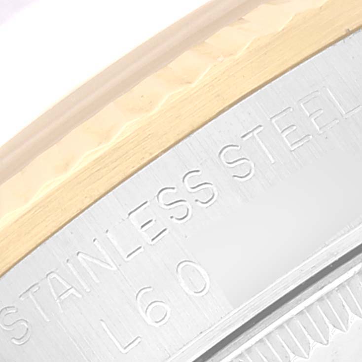 The image shows a close-up of the engraved stainless steel back and edge of the bezel on a Mid-Size Rolex watch.