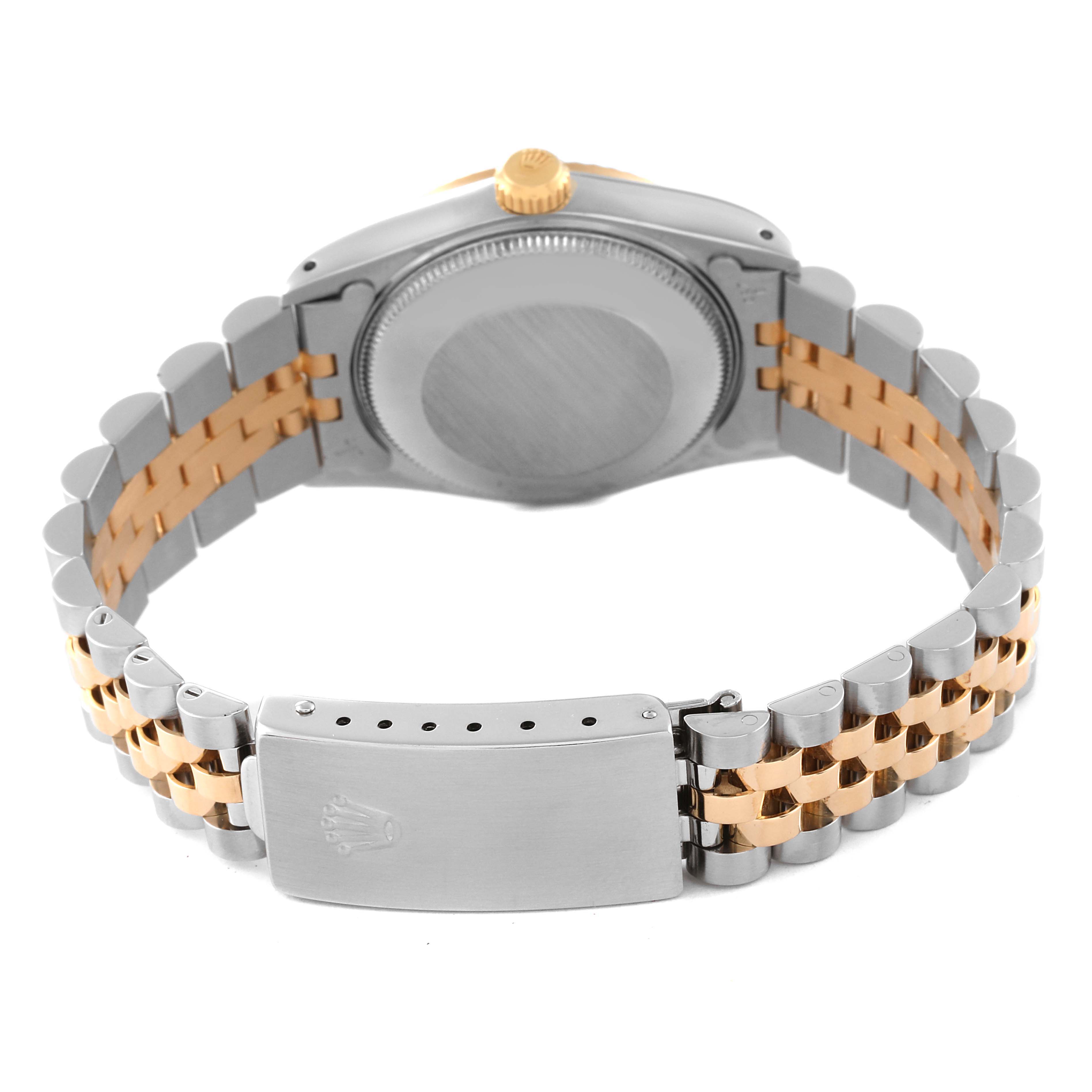 The image shows the case back and bracelet of a mid-size Rolex watch, focusing on the clasp and bi-metal link design.