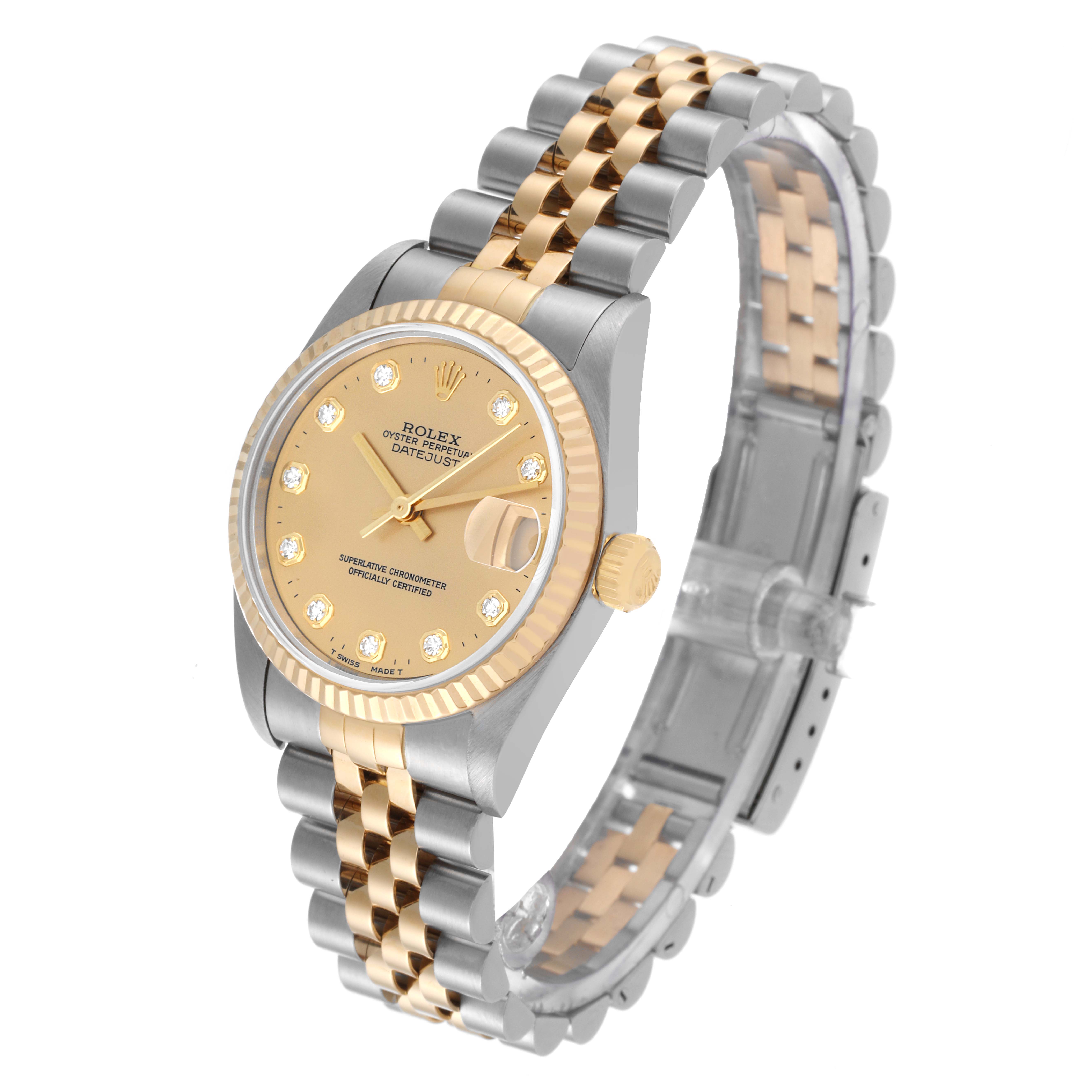 This image shows a Mid-Size Rolex Datejust watch displayed at an angle highlighting the gold dial, fluted bezel, and two-tone bracelet.