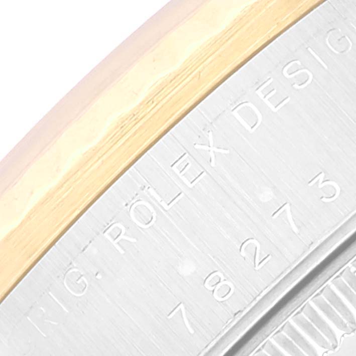 The image shows a close-up of the side of a Rolex Mid-Size 78273 Women
s Steel and Gold (two tone) White Dial 78273 Women
s Steel and Gold (two tone) White Dial watch, highlighting the engraved model number and design details.