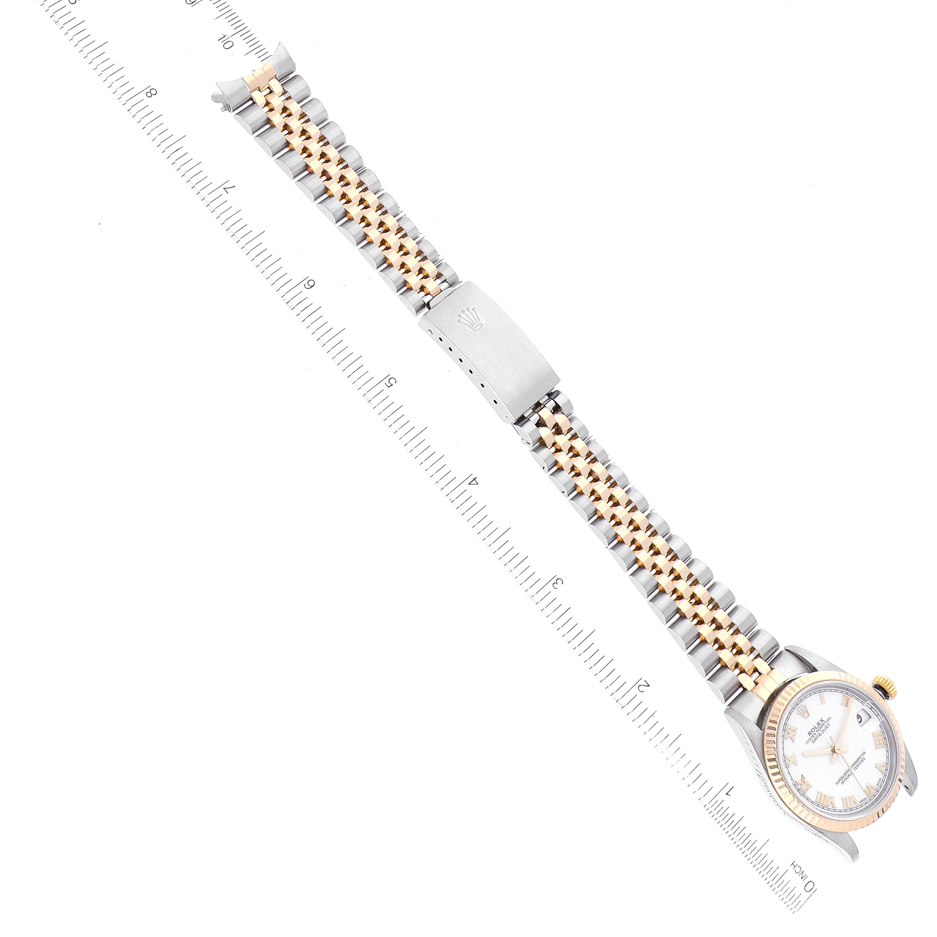 The Rolex Mid-Size 78273 Women
s Steel and Gold (two tone) White Dial 78273 Women
s Steel and Gold (two tone) White Dial model is shown from a top view, displaying the watch face and full bracelet against a ruler for scale.