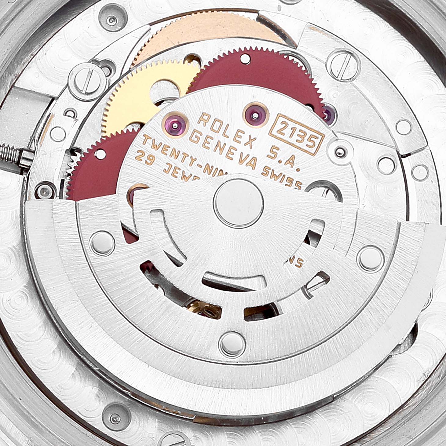 This is a close-up view of the internal movement mechanism of a Mid-Size Rolex watch, showcasing gears and inscriptions.