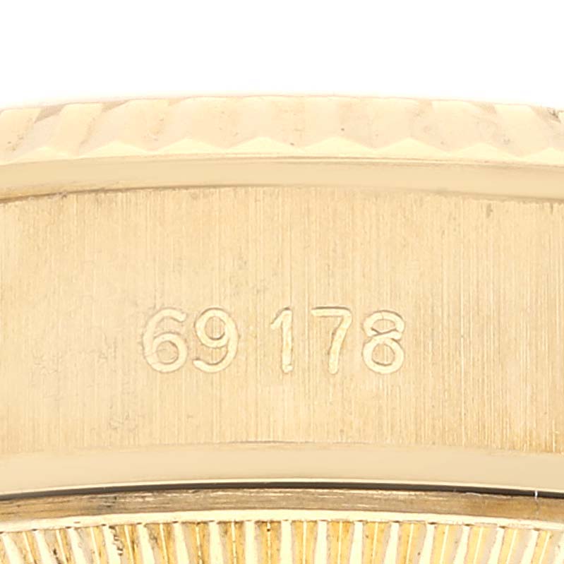 The image shows a close-up of the side of a Rolex President 69178 Women's Yellow Gold Champagne Dial 69178 Women's Yellow Gold Champagne Dial model watch, highlighting the engraved model number 69178.
