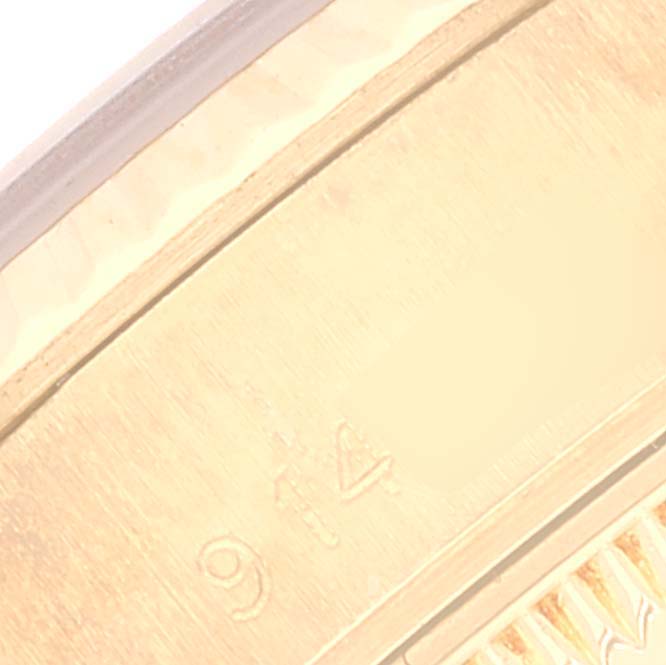 This close-up image shows part of the gold fluted bezel and the hallmark stamp on the Rolex President 69178 Women's Yellow Gold Champagne Dial 69178 Women's Yellow Gold Champagne Dial model watch.