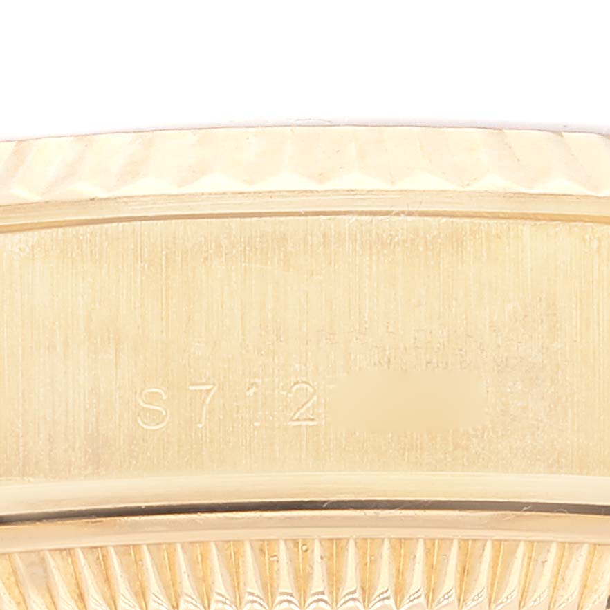 This image shows a close-up of the case and bezel of the Rolex President 69178 Women's Yellow Gold Champagne Dial 69178 Women's Yellow Gold Champagne Dial model watch, highlighting its serial number.
