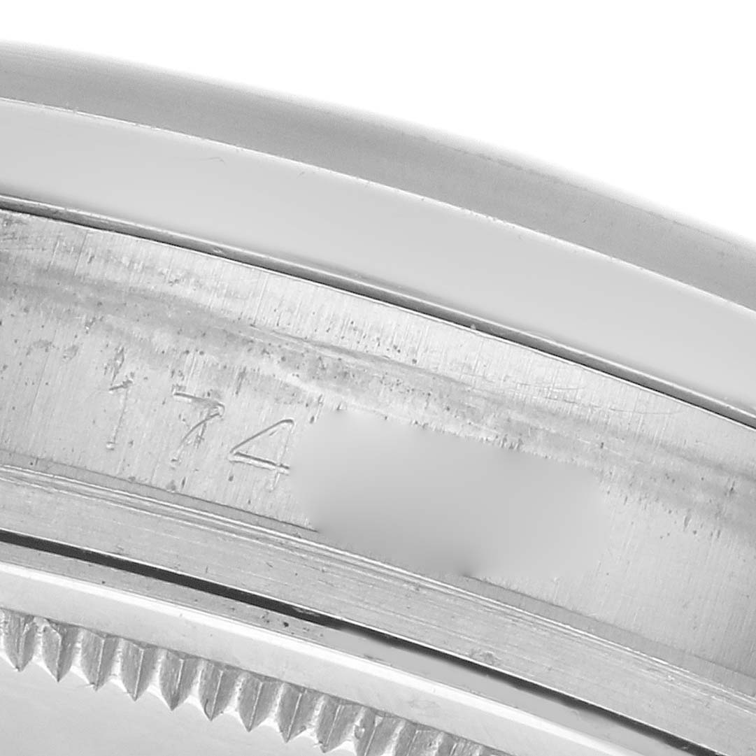 The image shows a close-up of the side of a Rolex Datejust 1600 Men
s Stainless Steel Silver Dial 1600 Men
s Stainless Steel Silver Dial watch, highlighting the engraved inner bezel and fluted edge.