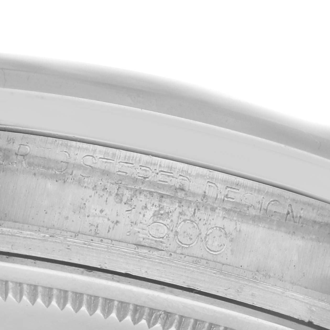 The image shows a close-up of the inner bezel engraving on a Rolex Datejust 1600 Men
s Stainless Steel Silver Dial 1600 Men
s Stainless Steel Silver Dial watch, highlighting the text and serial details.