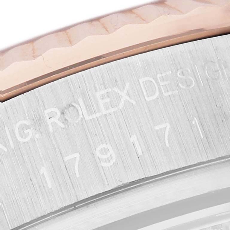 This close-up image shows the side of a Rolex Datejust 179171 Women's Steel and Gold (two tone) White Dial 179171 Women's Steel and Gold (two tone) White Dial watch, highlighting the serial number and part of the bezel.