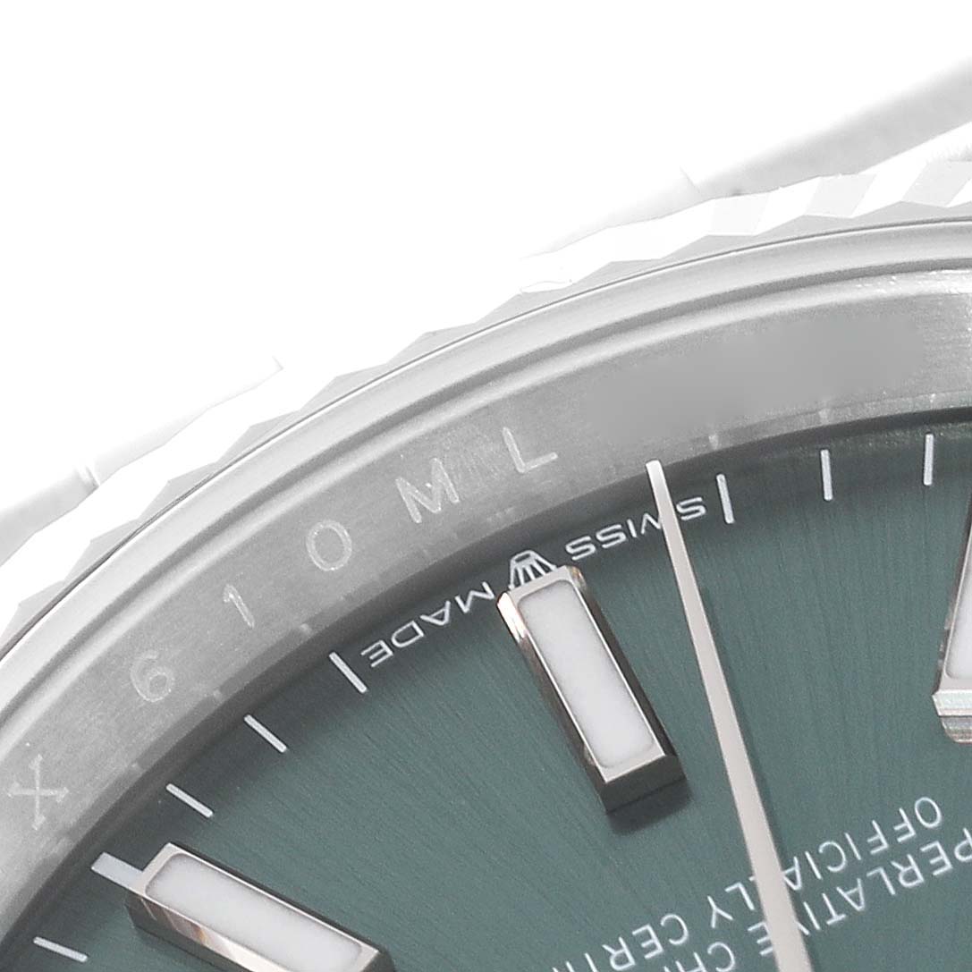 This image shows a close-up of the bezel and dial of a Rolex Datejust 126234 Men's Stainless Steel Green Dial 126234 Men's Stainless Steel Green Dial watch, focusing on the "Swiss Made" text and hour markers.