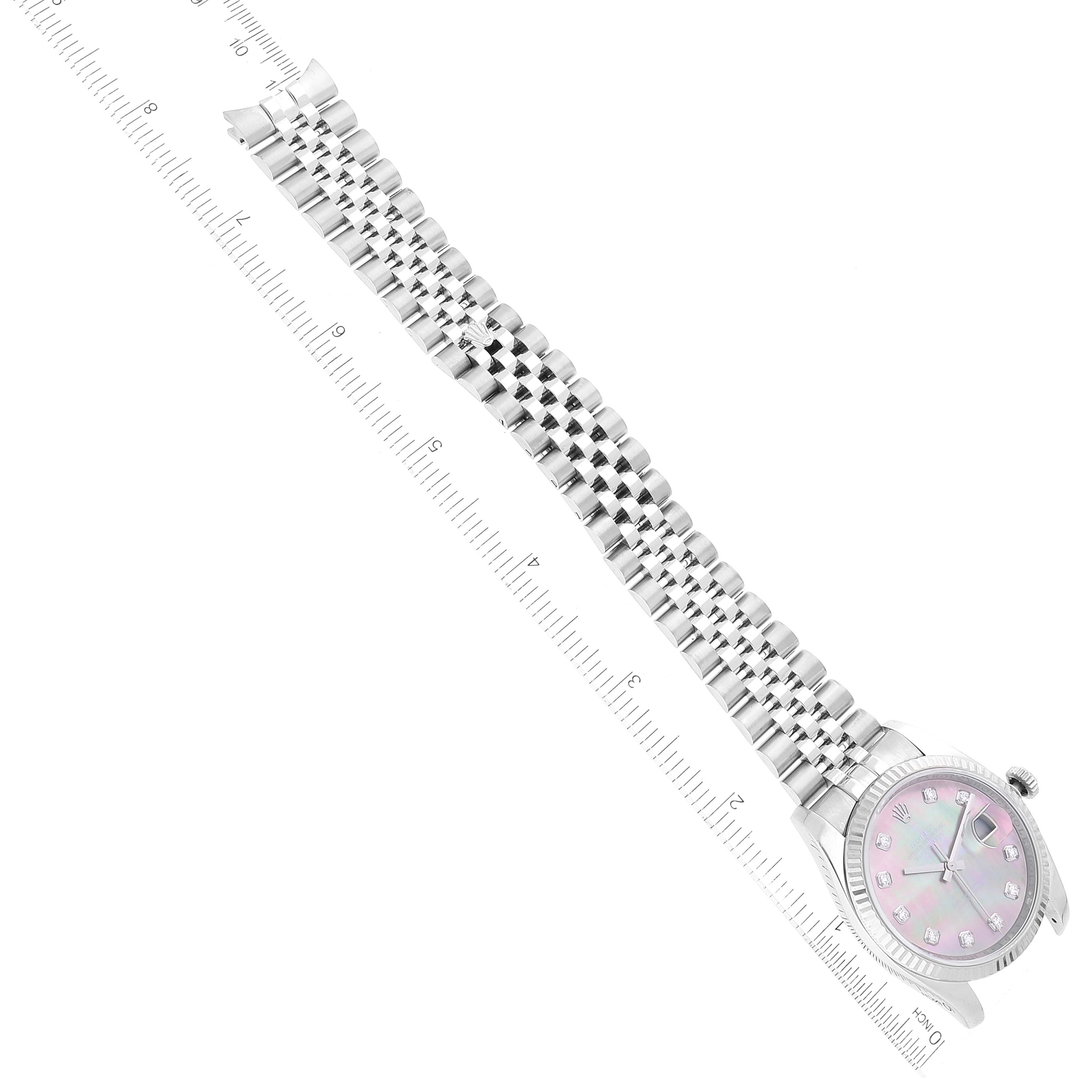 The image shows a Rolex Datejust 116234 Men's Stainless Steel Mother of Pearl Dial 116234 Men's Stainless Steel Mother of Pearl Dial watch laying horizontally, capturing the full length of its band and face with rulers for scale.