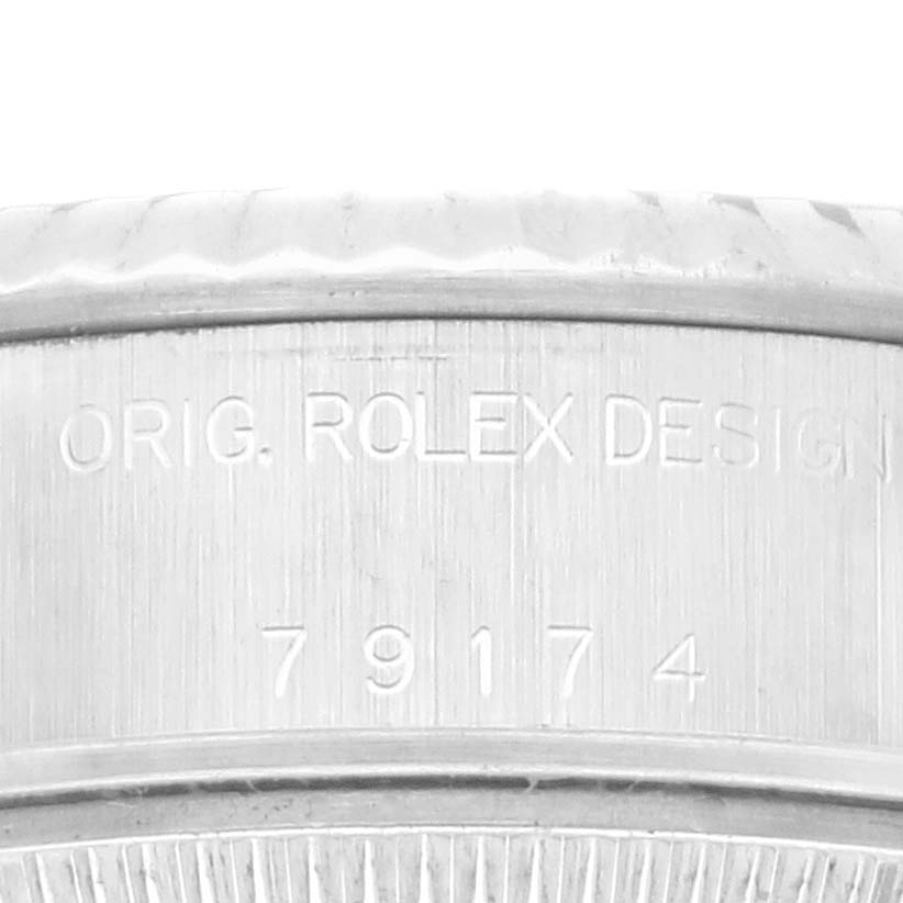 This image shows the side engraving of a Rolex Datejust 79174 Women's Stainless Steel Pink Dial 79174 Women's Stainless Steel Pink Dial, highlighting the model number and "ORIG. ROLEX DESIGN" inscription. 