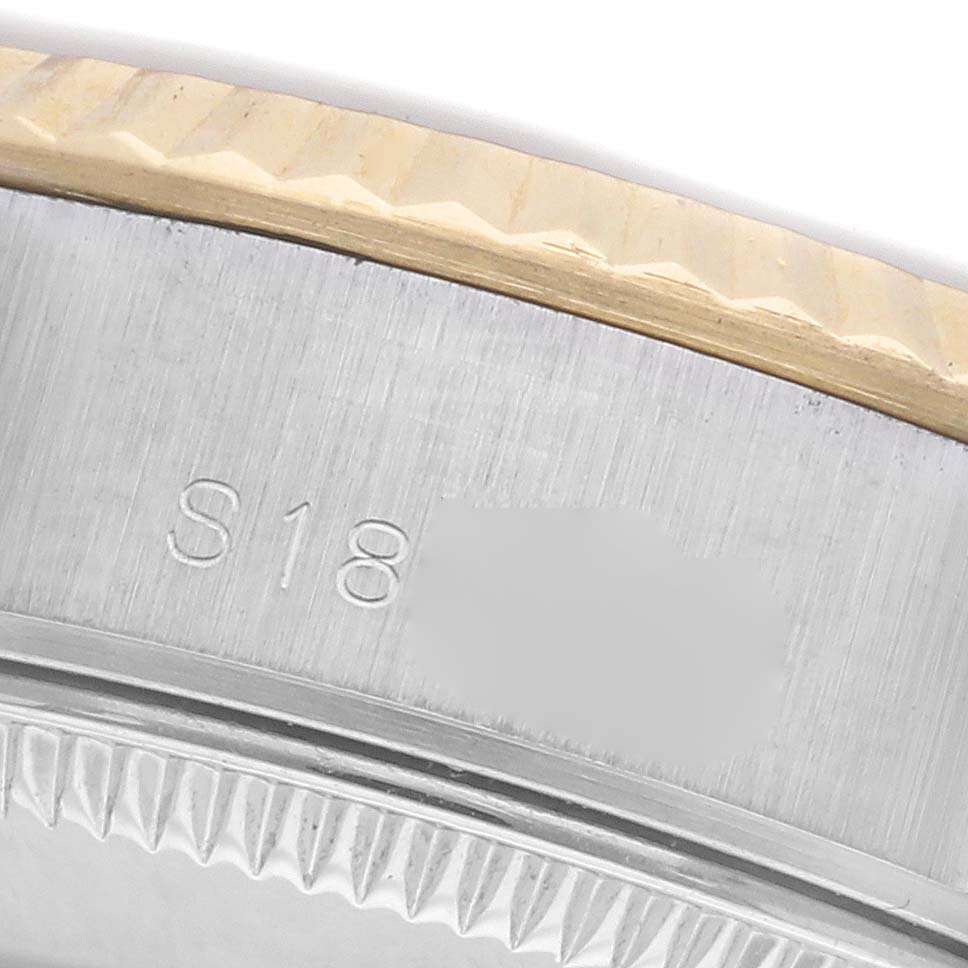 The image shows a close-up of the side engraving and fluted bezel of a Rolex Datejust 69173 Women's Steel and Gold (two tone) Champagne Dial 69173 Women's Steel and Gold (two tone) Champagne Dial watch.