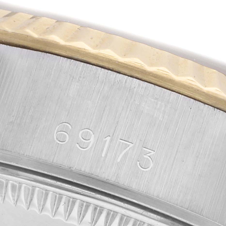 The image shows a close-up of a Rolex Datejust 69173 Women's Steel and Gold (two tone) Champagne Dial 69173 Women's Steel and Gold (two tone) Champagne Dial model's case side, displaying the model number and part of the fluted bezel.