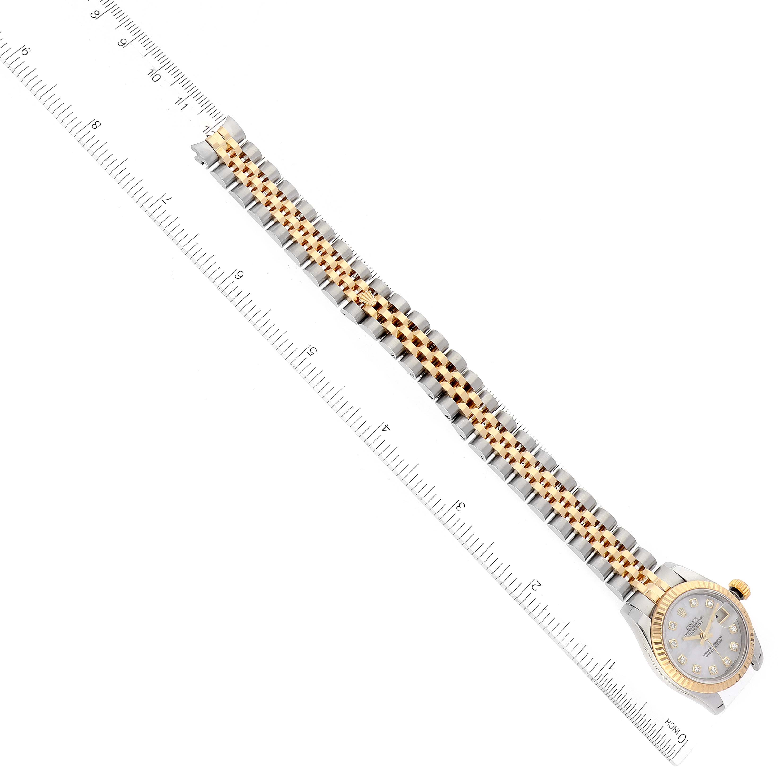The image shows the Rolex Datejust 179173 Women's Steel and Gold (two tone) Mother of Pearl Dial 179173 Women's Steel and Gold (two tone) Mother of Pearl Dial watch laying flat, displaying the full length of its wristband alongside a ruler for scale.
