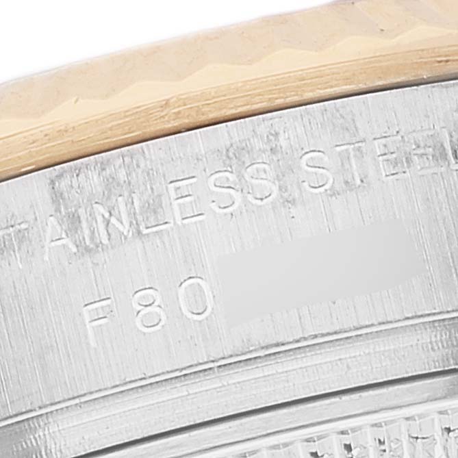 This image shows a close-up of the side of a Rolex Datejust 179173 Women's Steel and Gold (two tone) Mother of Pearl Dial 179173 Women's Steel and Gold (two tone) Mother of Pearl Dial watch, highlighting the stainless steel engraving.