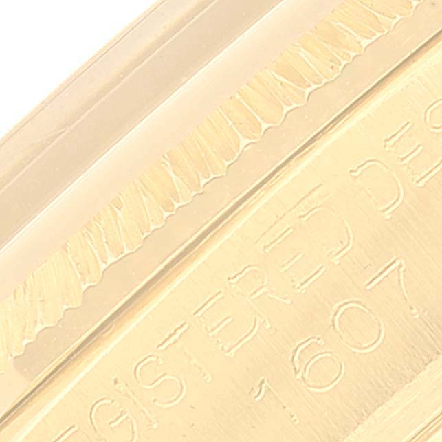 This close-up image of the Vintage Collection Rolex watch highlights the engraved text and the ridged edging.