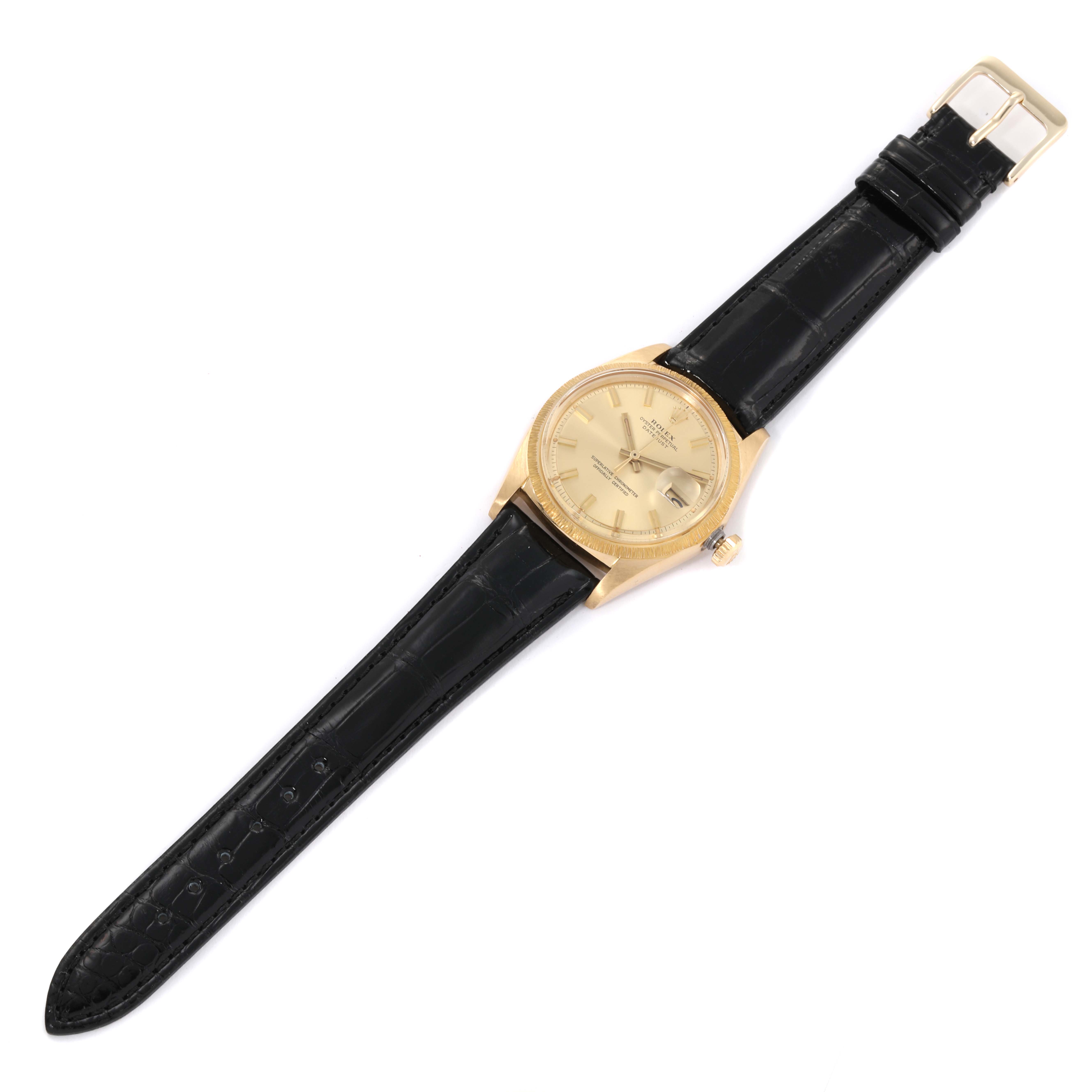 The Rolex Vintage Collection 1607 Men's Yellow Gold Champagne Dial 1607 Men's Yellow Gold Champagne Dial watch is shown from a top-down angle, displaying the face, bezel, and full black leather strap.