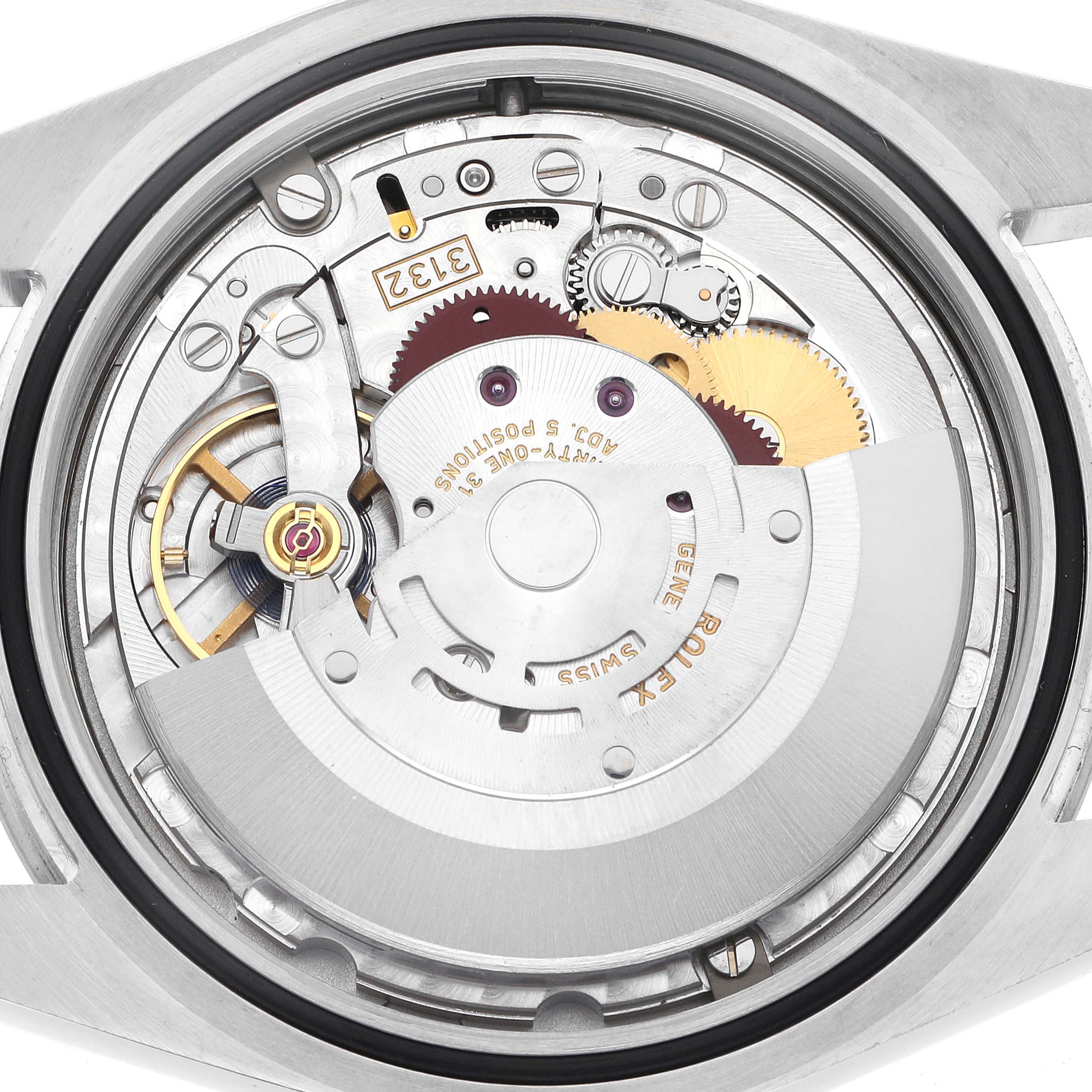 The image shows the inner mechanism of a Rolex Explorer 214270 Men's Stainless Steel Black Dial 214270 Men's Stainless Steel Black Dial watch, displaying gears, rotors, and other intricate components.