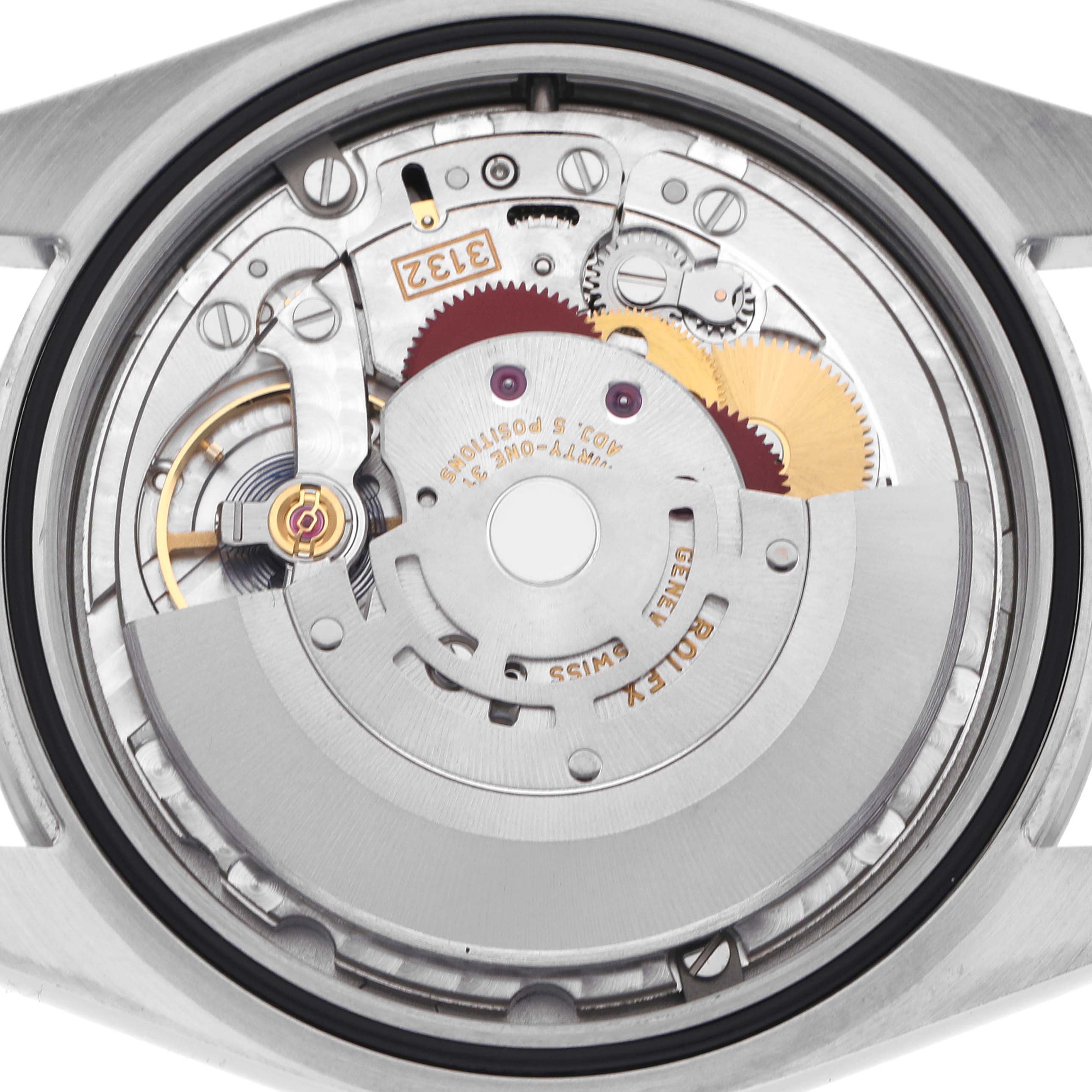 The image shows the movement of a Rolex Explorer 214270 Men
s Stainless Steel Black Dial 214270 Men
s Stainless Steel Black Dial watch from a top-down view, highlighting the intricate gears and rotor.