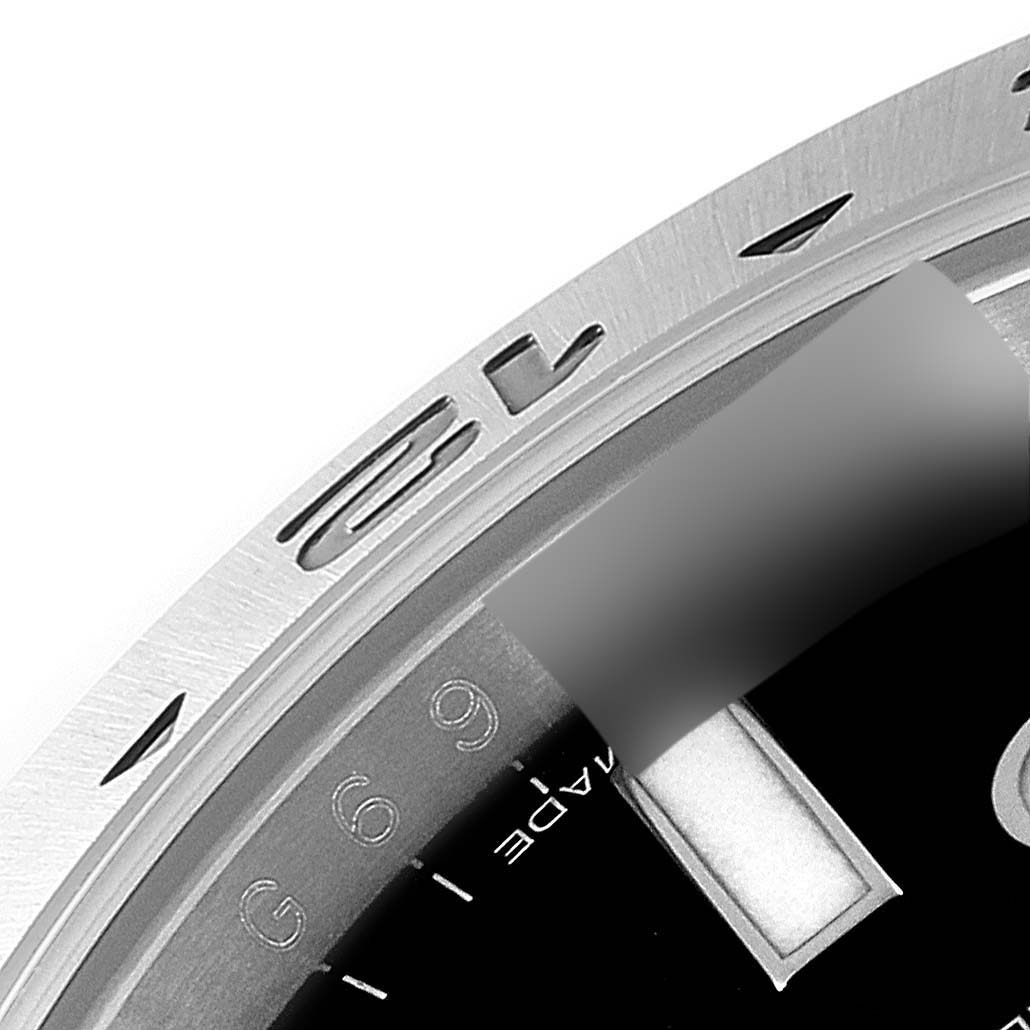 The image shows a close-up of the bezel, chapter ring, and part of the dial of a Rolex Explorer 216570 Men
s Stainless Steel Black Dial 216570 Men
s Stainless Steel Black Dial watch.