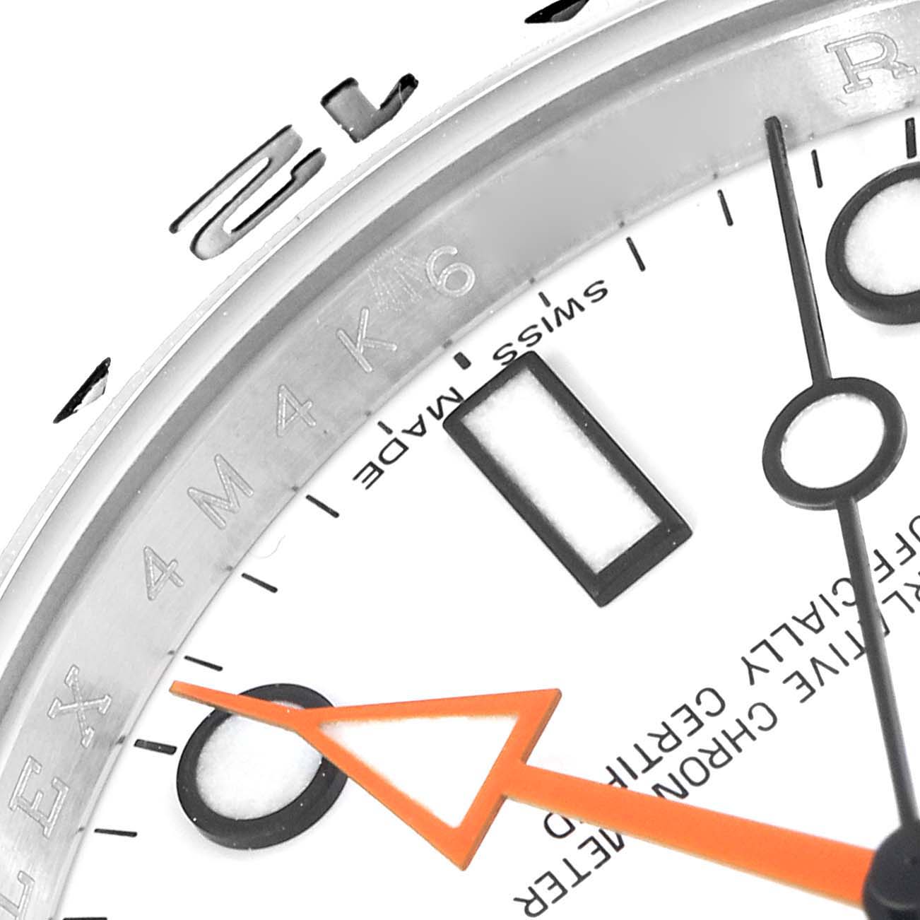 This close-up of the Rolex Explorer 216570 Men's Stainless Steel White Dial 216570 Men's Stainless Steel White Dial watch shows the bezel, part of the dial, and the second hand.
