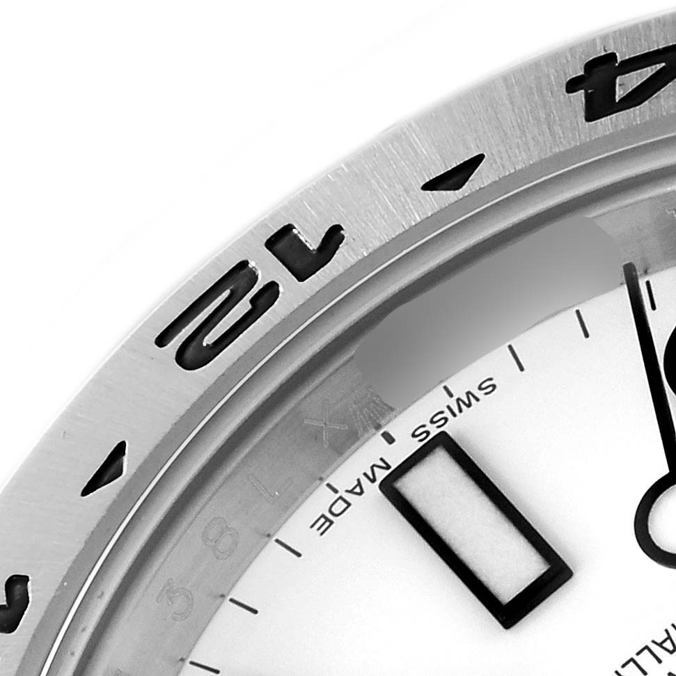 The image shows a close-up of the bezel, dial, and hands of a Rolex Explorer 216570 Men
s Stainless Steel White Dial 216570 Men
s Stainless Steel White Dial watch.