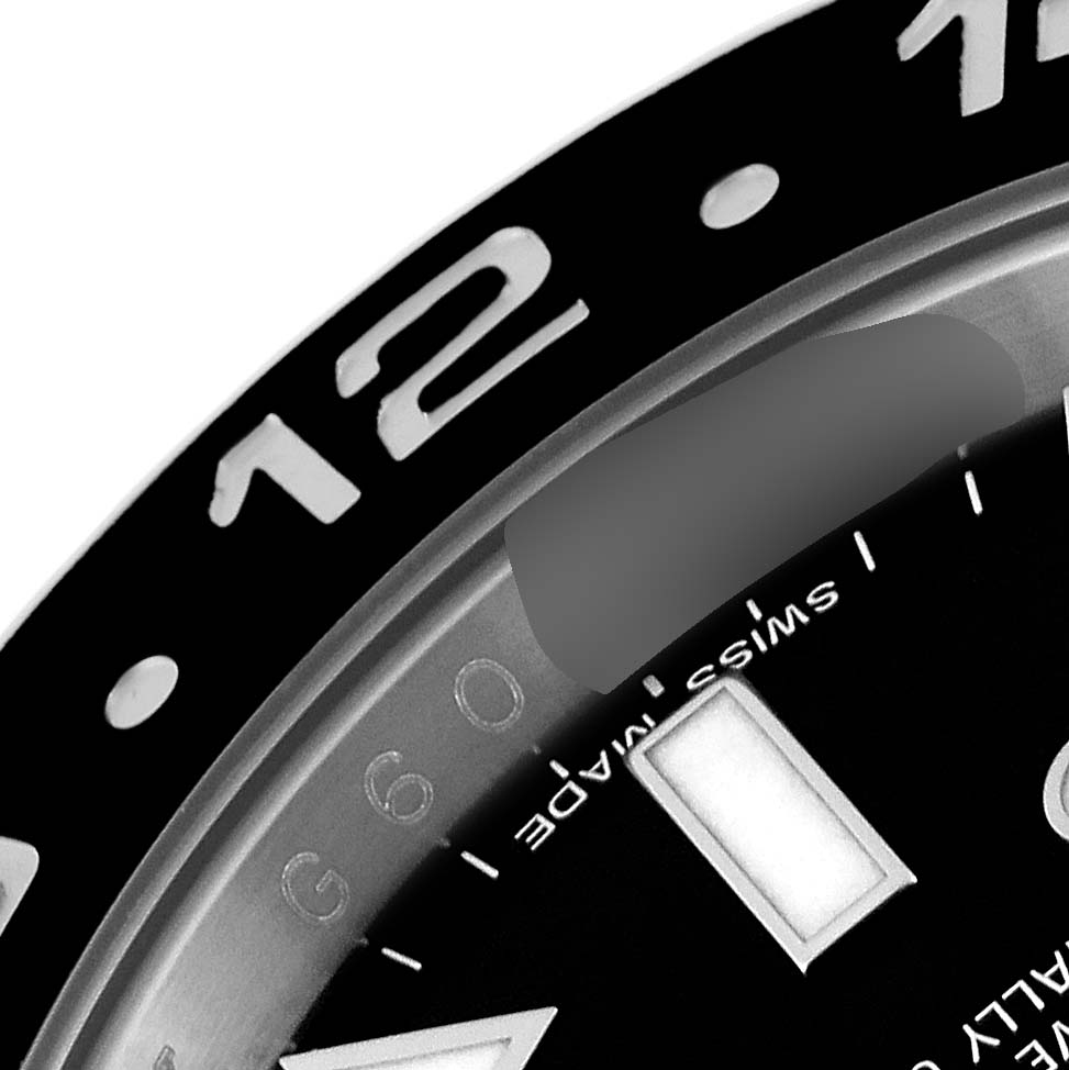 This image shows a close-up of the bezel, part of the dial, and the “Swiss Made” text on the Rolex GMT-Master 116710 Men
s Stainless Steel Black Dial 116710 Men
s Stainless Steel Black Dial watch.