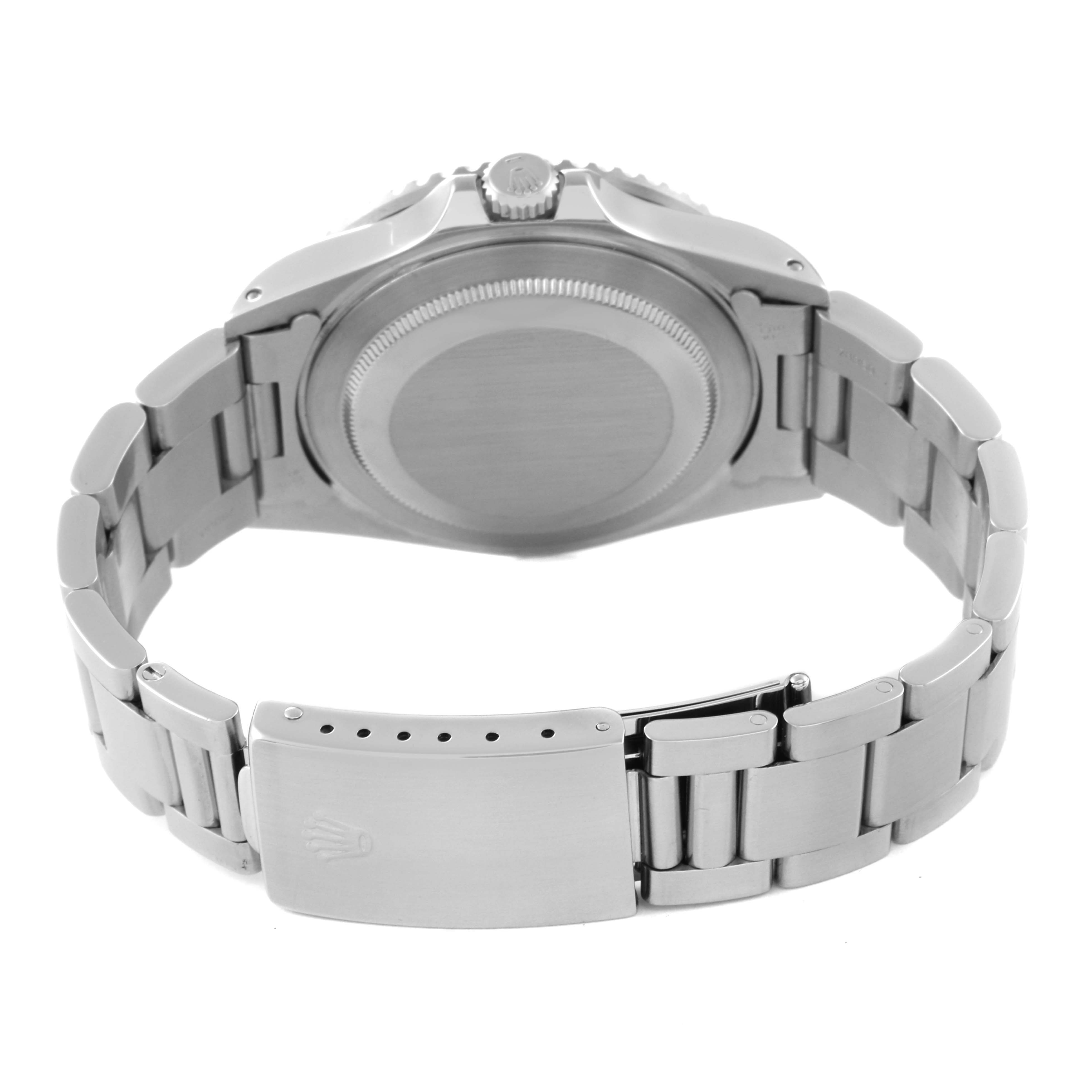 This image shows the Rolex GMT-Master 16710 Men's Stainless Steel Black Dial 16710 Men's Stainless Steel Black Dial watch, specifically the case back, crown, and closed clasp of the metal bracelet, at a reverse angle.