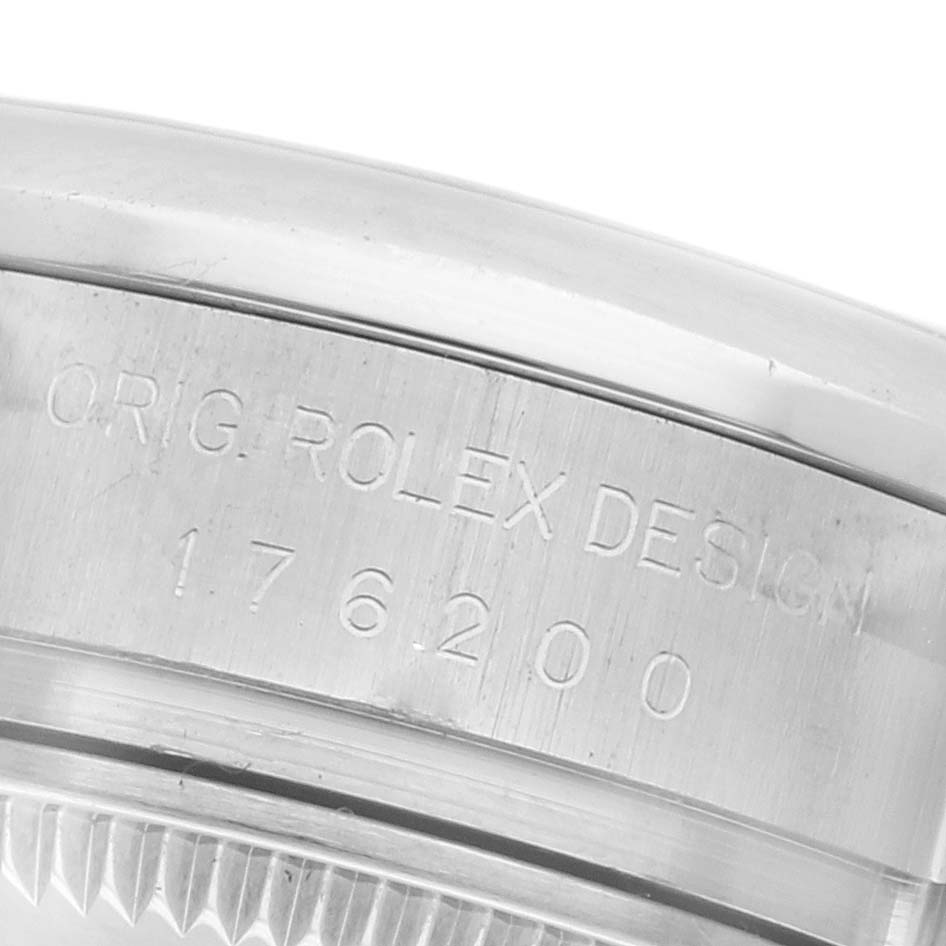 The image shows a close-up side view of the Rolex Oyster Perpetual 176200 Women's Stainless Steel Silver Dial 176200 Women's Stainless Steel Silver Dial's case with engraved design and model number.