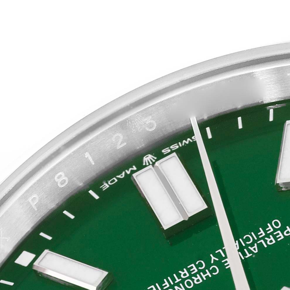 This close-up image shows part of the green dial, the indices, and a portion of the bezel of the Rolex Oyster Perpetual 124300 Men
s Stainless Steel Green Dial 124300 Men
s Stainless Steel Green Dial watch.
