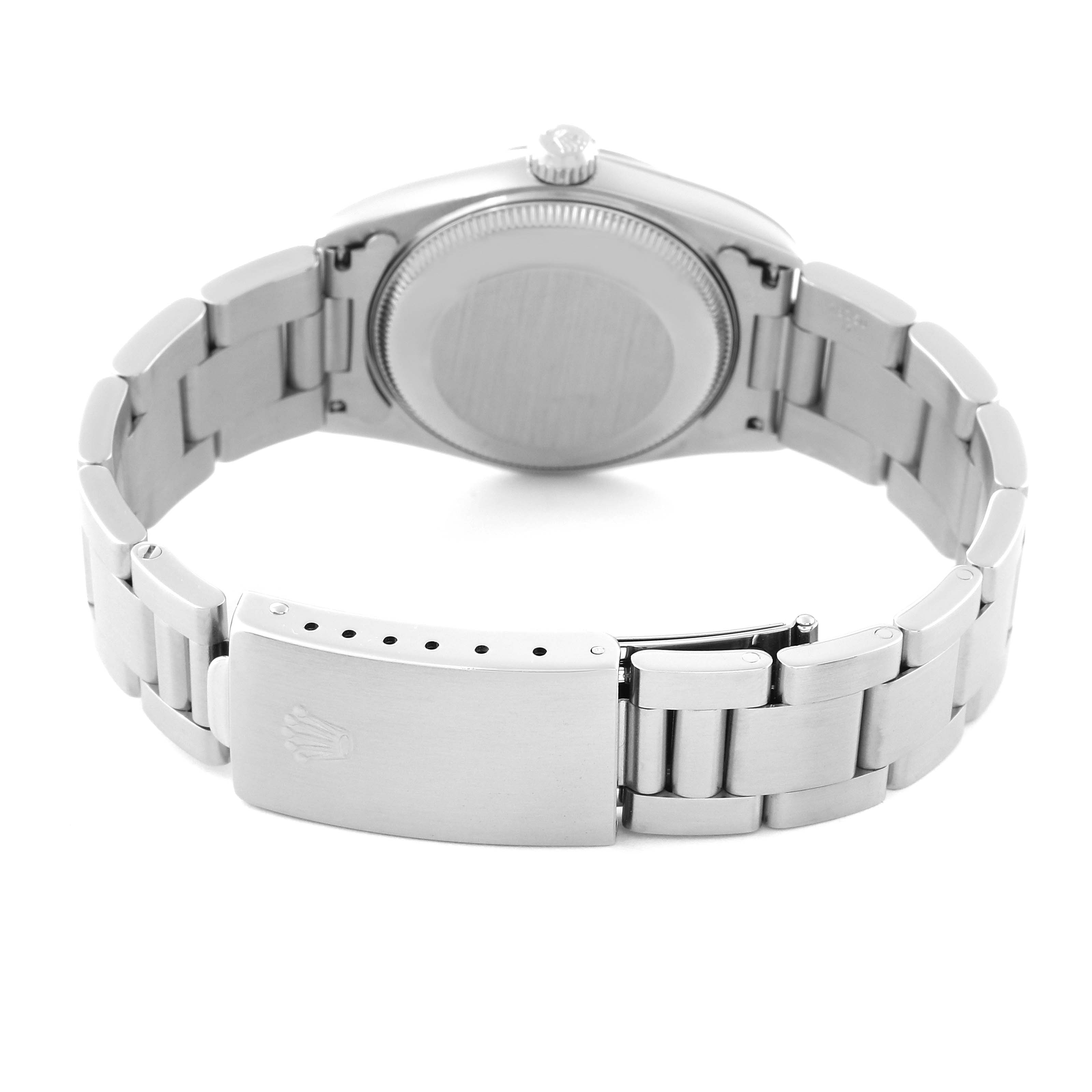 The image shows the backside view of a Rolex Oyster Perpetual watch, highlighting the case back, crown, bracelet, and clasp.