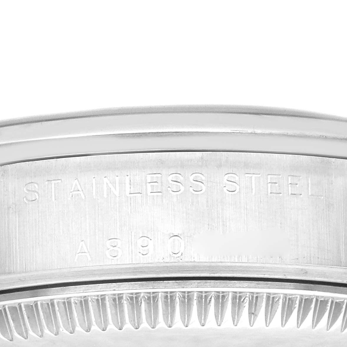 This image shows a close-up view of the case back of a Rolex Oyster Perpetual, highlighting the "Stainless Steel" engraving.