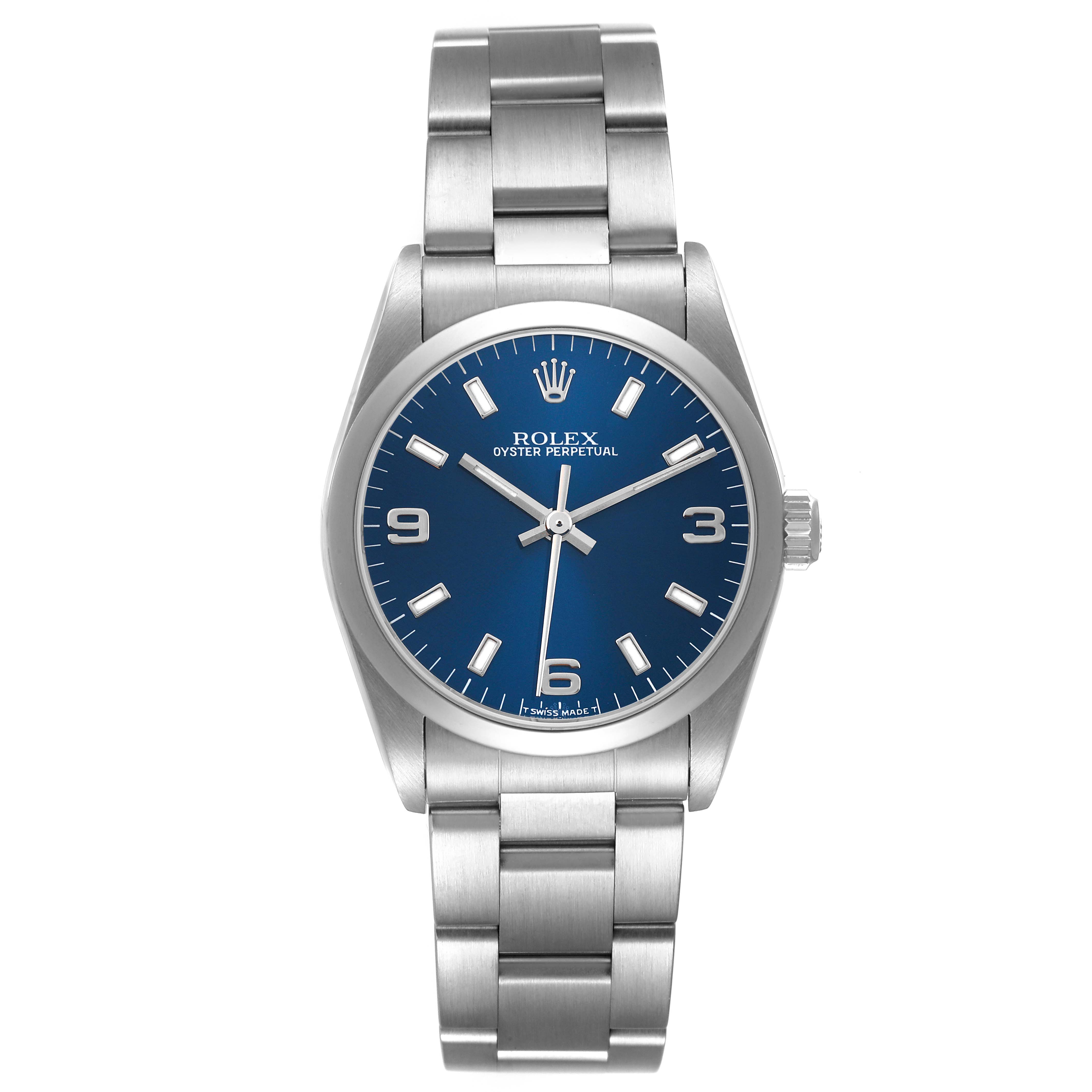 The image shows a front view of a Rolex Oyster Perpetual Mid-Size watch with a blue dial and silver bracelet.