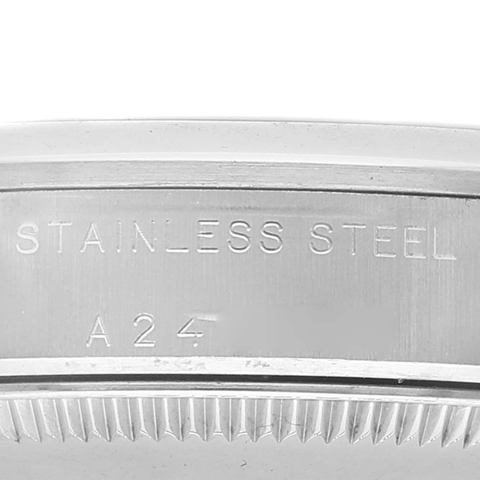 The image shows a close-up of the side of a stainless steel Rolex Mid-Size 77080 Women
s Stainless Steel Blue Dial 77080 Women
s Stainless Steel Blue Dial model watch case, including part of the model number.