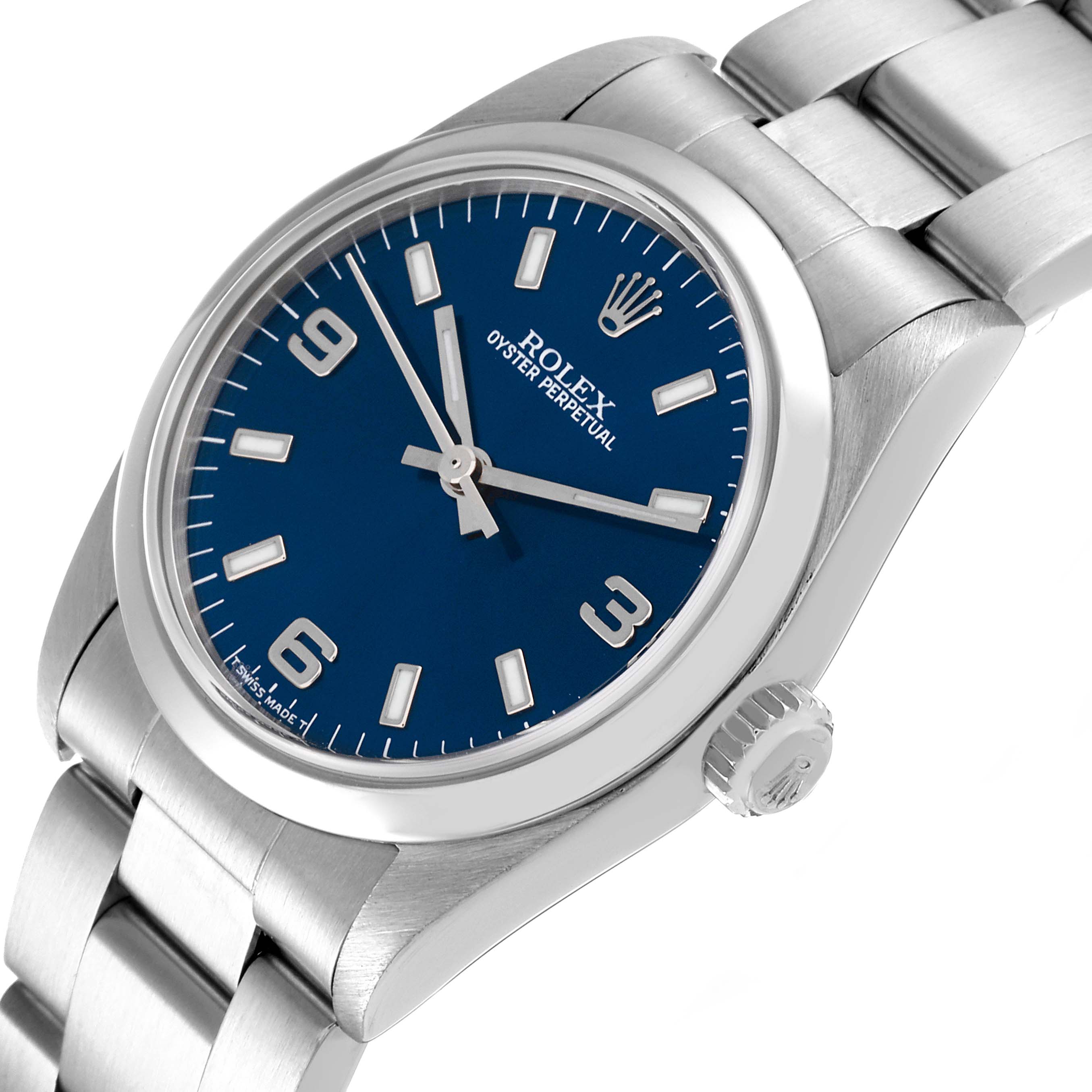 The image shows a Rolex Mid-Size 77080 Women
s Stainless Steel Blue Dial 77080 Women
s Stainless Steel Blue Dial Oyster Perpetual watch from a slightly tilted top angle, focusing on its blue dial and steel bracelet.