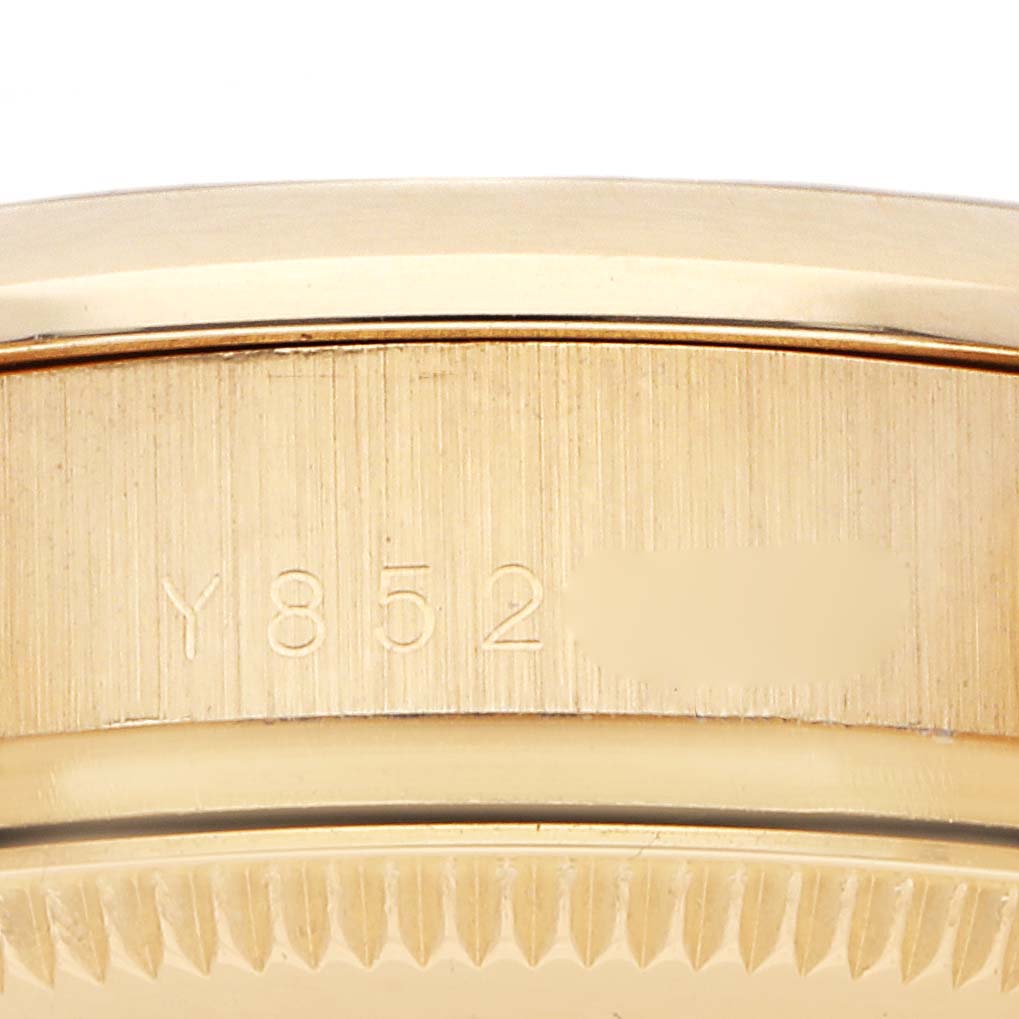 The image shows the side view of a Rolex Mid-Size watch case, highlighting the serial number engraving.