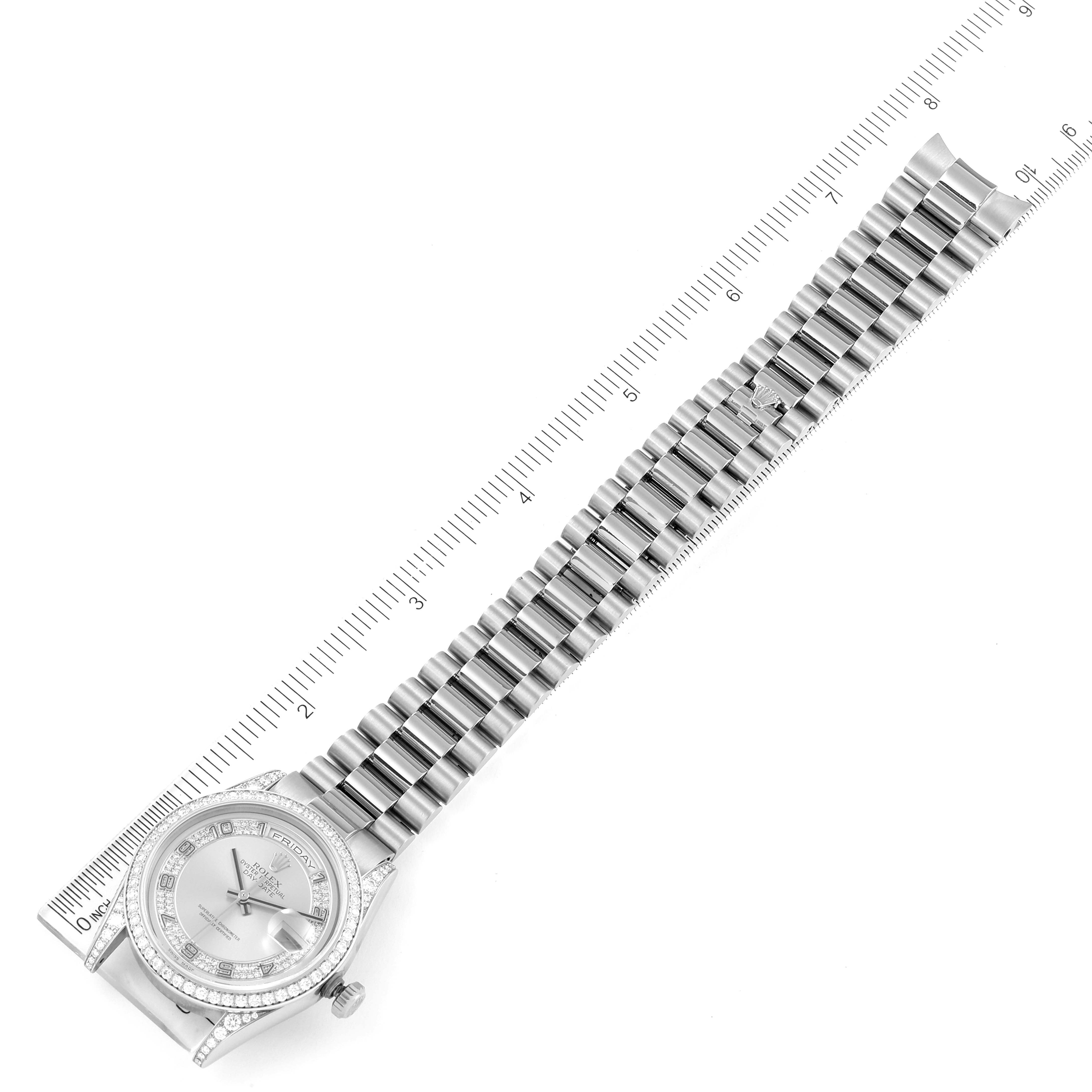 The image shows a top view of a Rolex President 118389 Men's White Gold Silver Dial 118389 Men's White Gold Silver Dial model watch with a ruler beside it, highlighting the full bracelet and the watch face.