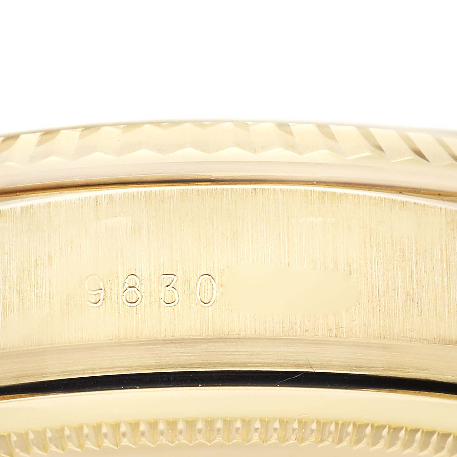 This image shows a close-up of the case and bezel of a Rolex President 18038 Men
s Yellow Gold Champagne Dial 18038 Men
s Yellow Gold Champagne Dial model watch, focusing on its engravings and texture.