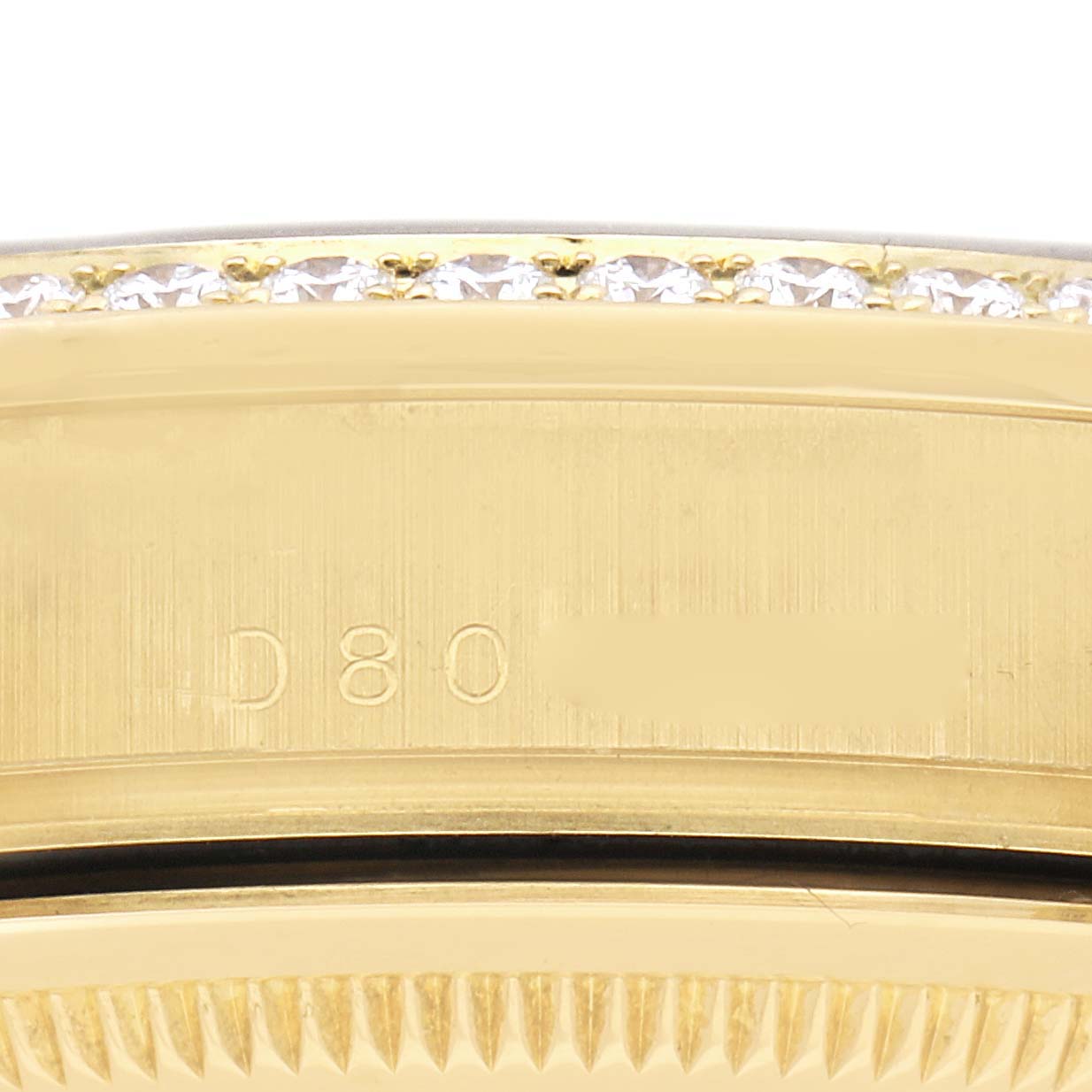 The image shows a close-up view of the engraved side of a Rolex President 118348 Men
s Yellow Gold Champagne Dial 118348 Men
s Yellow Gold Champagne Dial model, highlighting its bezel and part of the band.