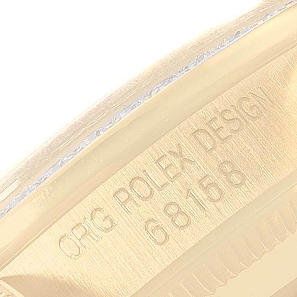 The image shows a close-up of the inner case of a Rolex President 68158 Women
s Yellow Gold Champagne Dial 68158 Women
s Yellow Gold Champagne Dial model watch with the engraving "ORIG ROLEX DESIGN 68158."