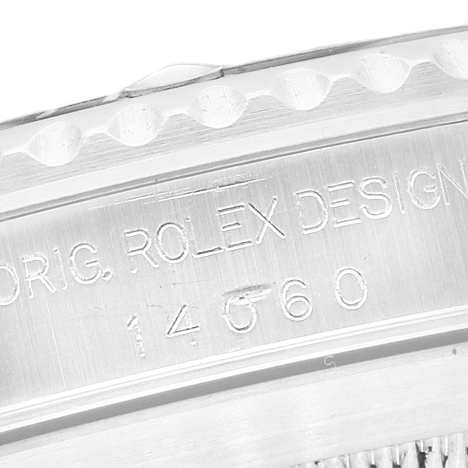 This image shows a close-up of the engraved side of the case and bezel of a Rolex Submariner 14060 Men
s Stainless Steel Black Dial 14060 Men
s Stainless Steel Black Dial watch.