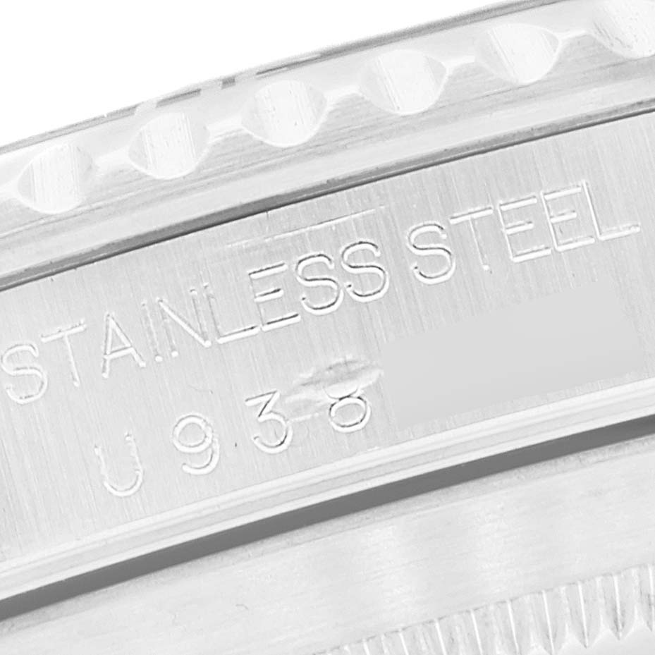 The image shows a close-up of the side of a Rolex Submariner 14060 Men
s Stainless Steel Black Dial 14060 Men
s Stainless Steel Black Dial watch case, highlighting the "STAINLESS STEEL" engraving.