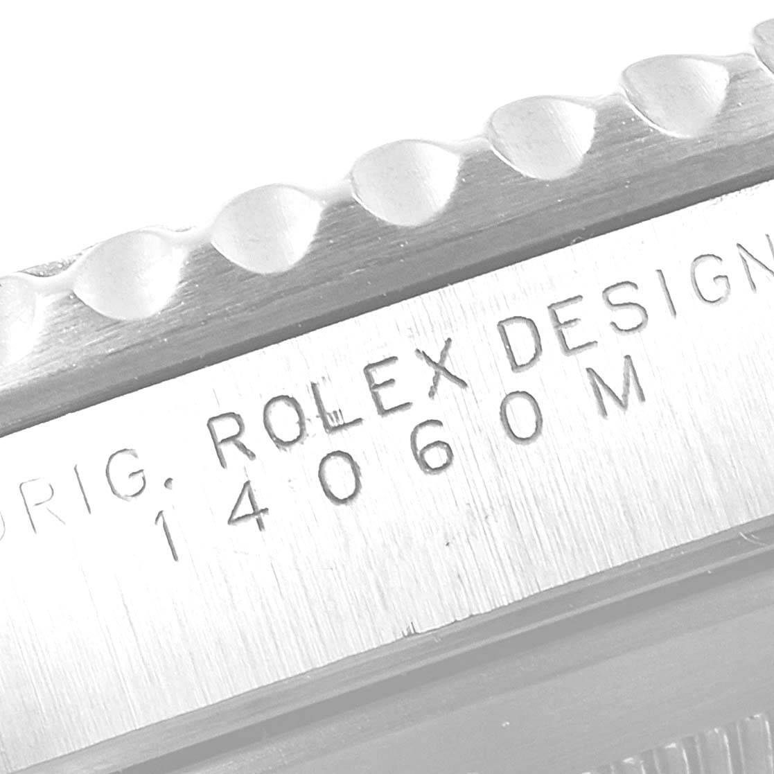 The image shows a close-up of the case
s edge and engraving of the Rolex Submariner 14060 Men
s Stainless Steel Black Dial 14060 Men
s Stainless Steel Black Dial watch, model number 14060M.